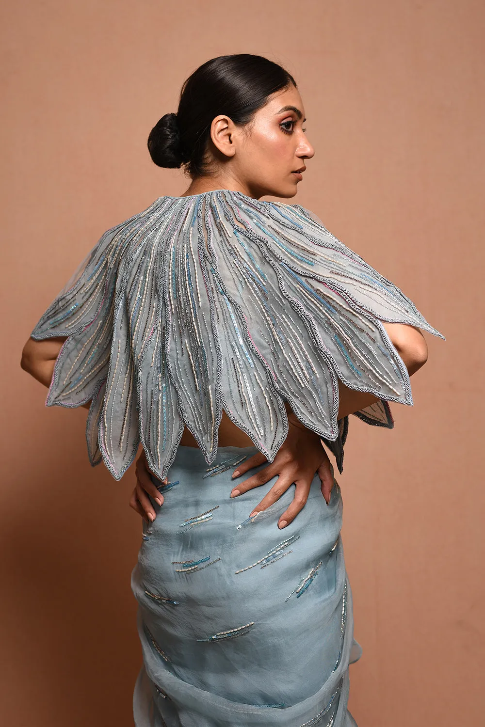 Foliage Saree Gown Features Petalfoliage Cape Embellished In Artwork Portraying Petals, It Is Scalloped With Knoted Yarn And Appliqued With Silk Organza.